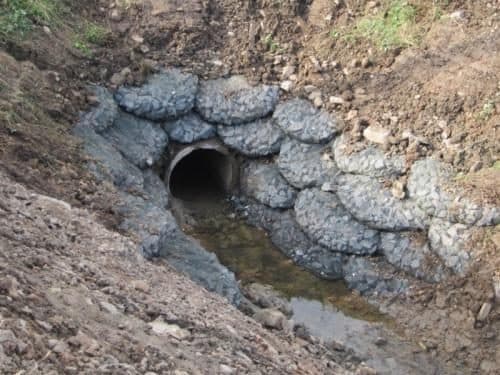 Rock bags surrounding a drainage outfall pipe