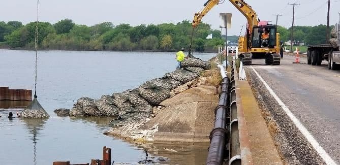 Rock bag revetment protecting a roadside river bank